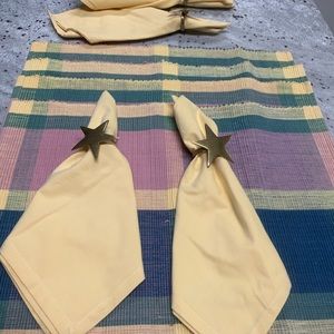 Set of Four Placemats with Four Yellow Cloth Napkins and Brass Star Napkin Rings